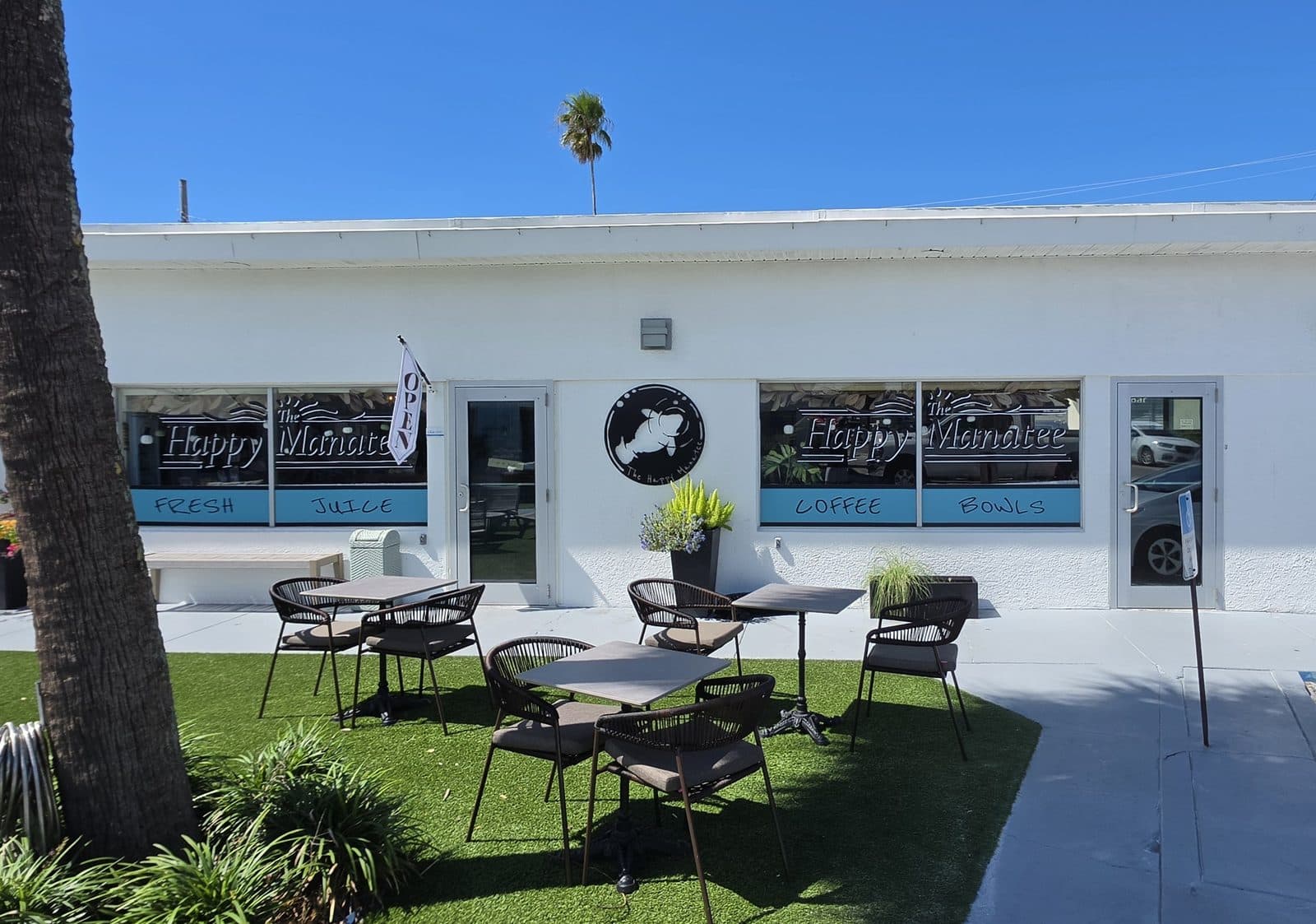 The Happy Manatee cafe from the lawn side, outdoor tables on the grass