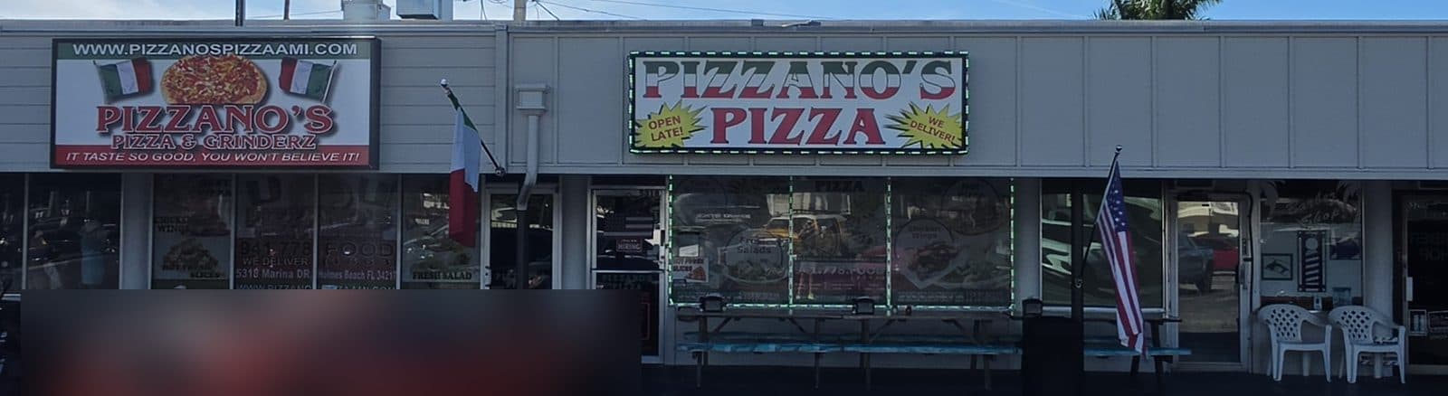 The two Pizzano's Pizza signs on a plaza storefront with a pizza picture and green and red lettering